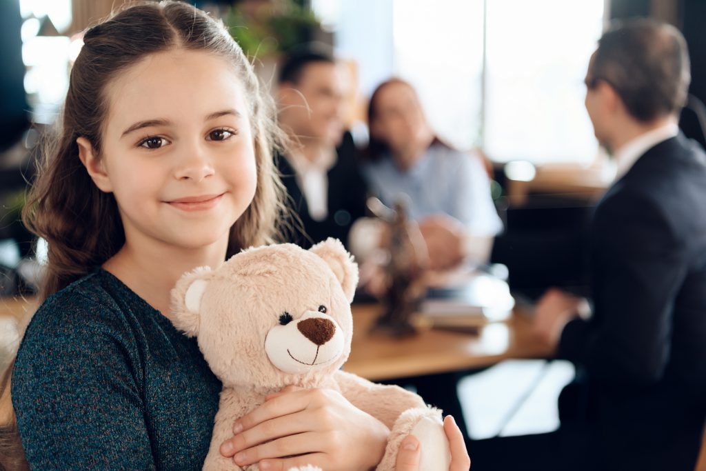 Beautiful girl with parents stands in the office.